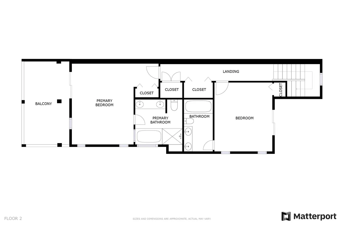 A spacious, light-filled primary bedroom featuring a large bed, modern closets, and an attached balcony with outdoor seating. The open layout includes glimpses of an en-suite bathroom, creating an inviting master suite atmosphere.